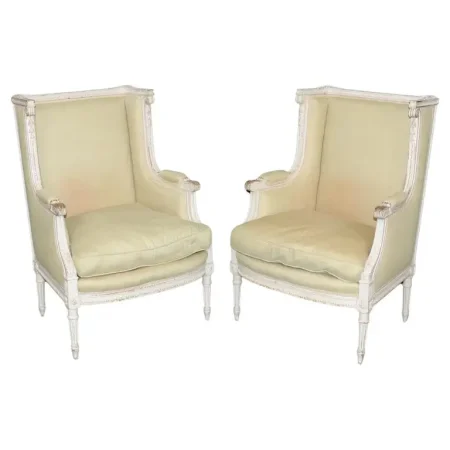 Exceptional pair of French Louis XVI Style Creme Painted Bergere Chairs