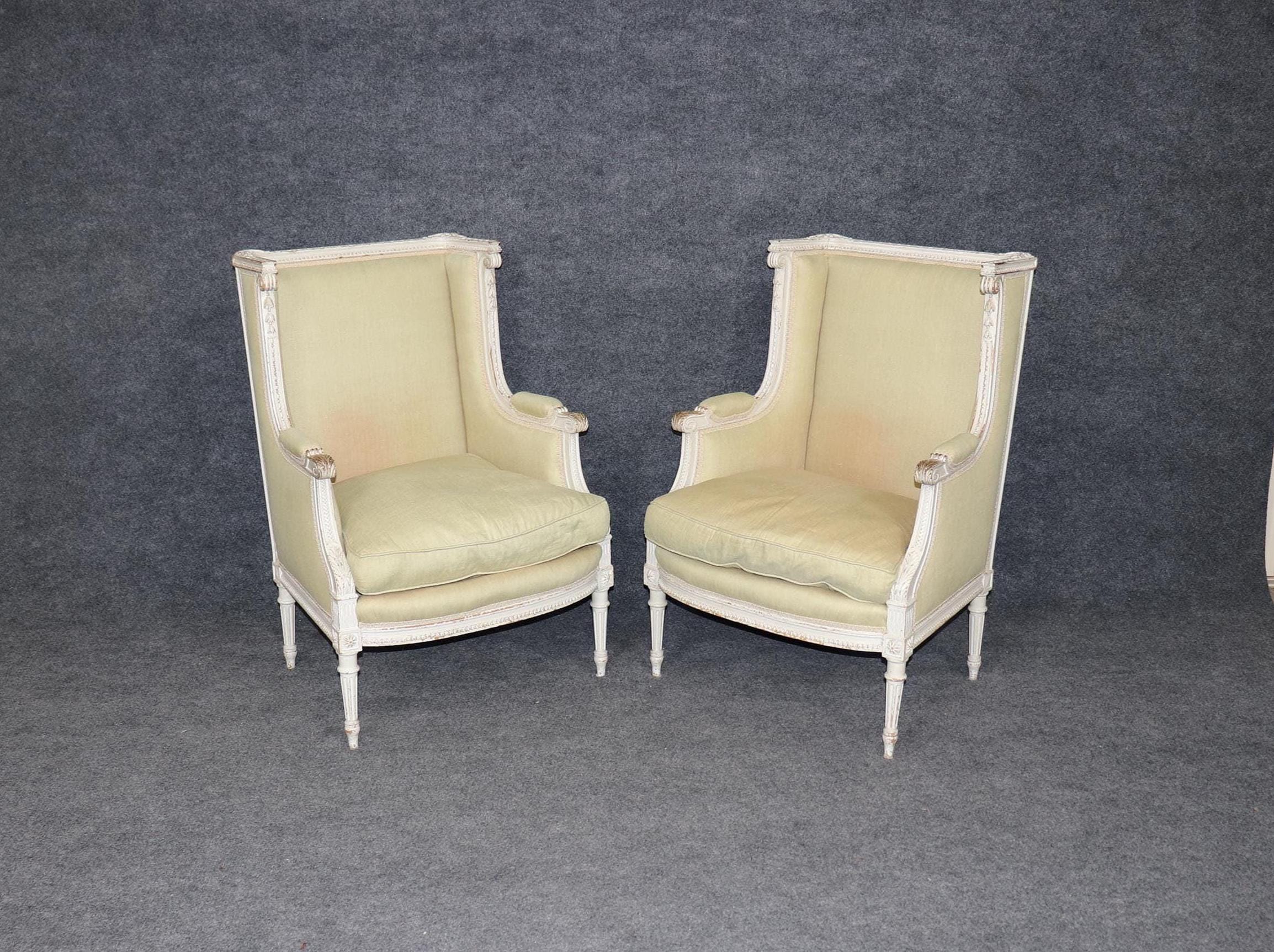 Exceptional Pair of Early 20th Century French Louis XVI Style Distressed Paint Decorated Wingback Bergeres, Pair Chairs
